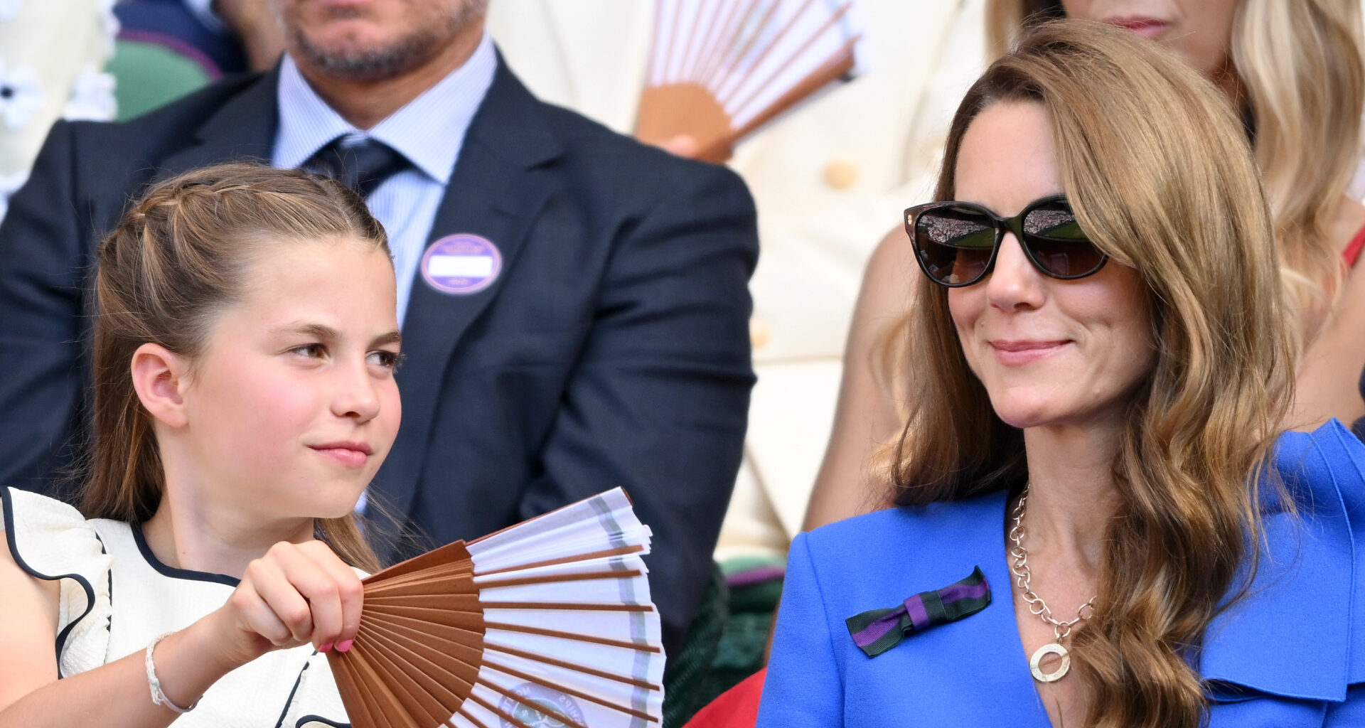 Princess Charlotte fans her mom Kate Middleton at Wimbledon as they watch the tennis tournament during a heat wave