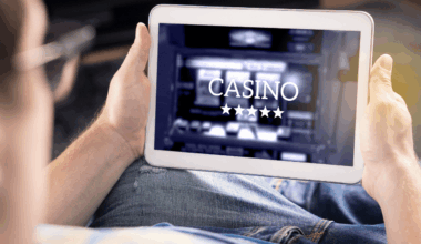 A person is accessing an online casino with a tablet