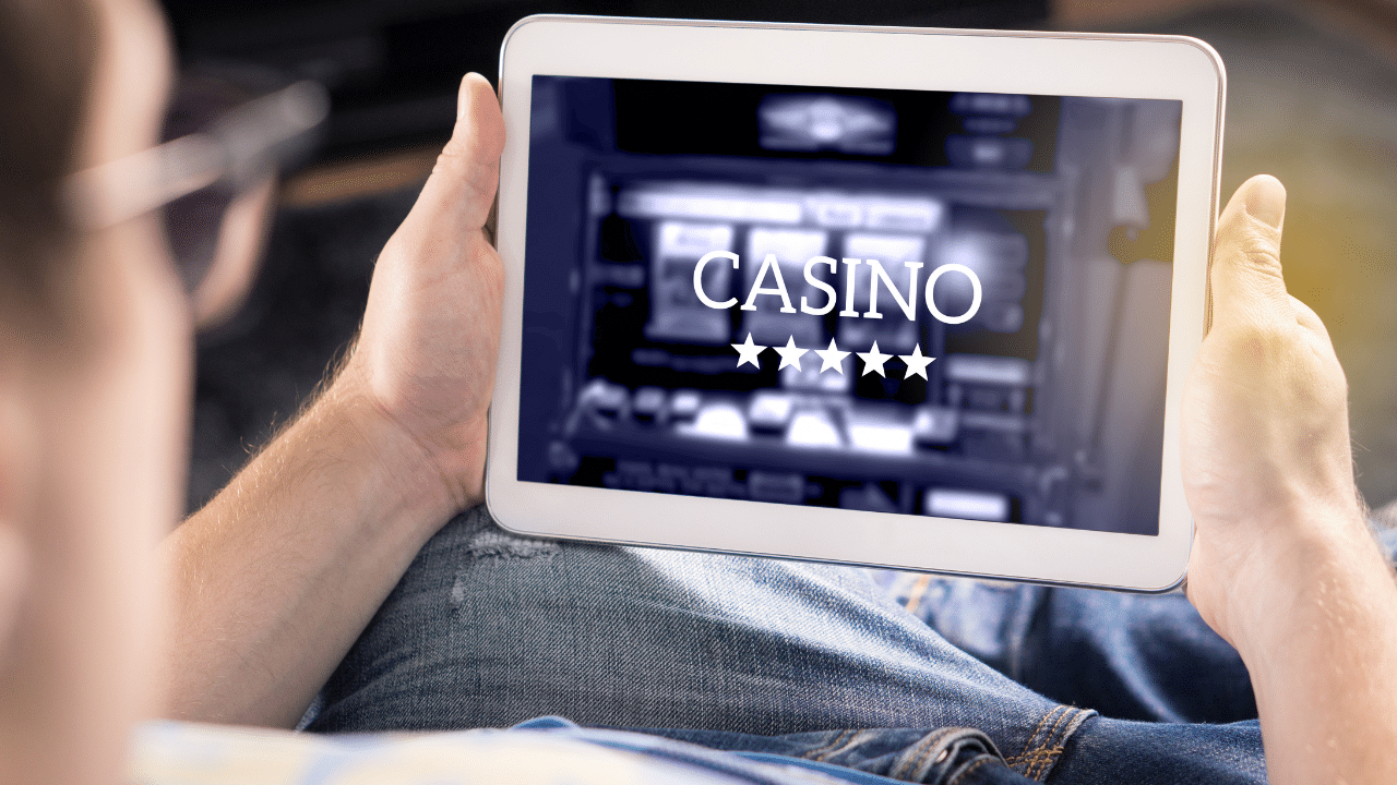 A person is accessing an online casino with a tablet