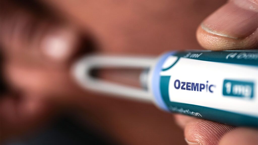 close-up of fingers holding Ozempic dose