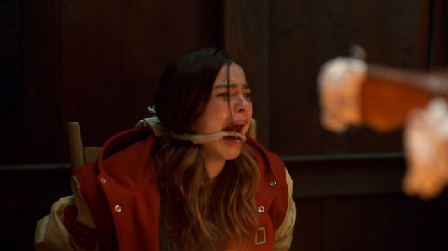 Addison Rae as Gaby screams while bound to a chair with a gag around her mouth in Thanksgiving
