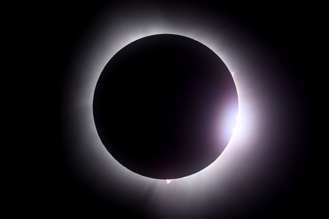 MARTIN, OHIO - APRIL 08: The moon passes in front of the sun during a solar eclipse on April 08, 2024 in Martin Ohio. Millions of people have flocked to areas across North America that are in the 