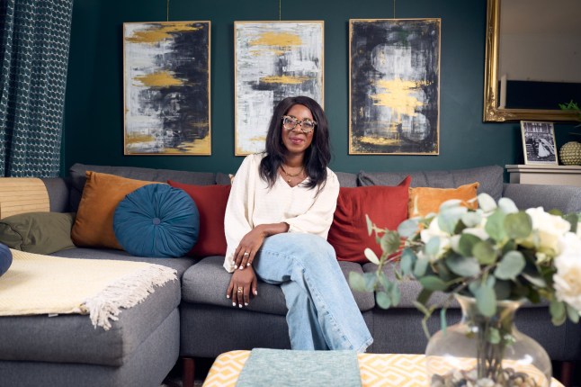 Orima Kamalu sits on the sofa inside her living room in Bristol.