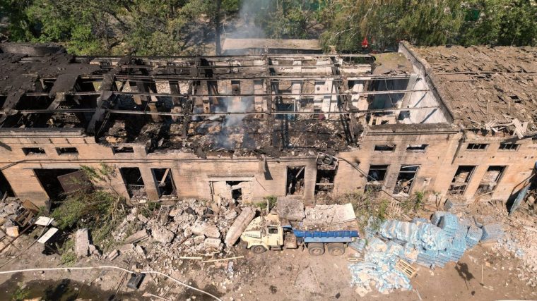 SLOVIANSK, UKRAINE - AUGUST 9: In this aerial view rescuers from the Emergency Services of Ukraine extinguish a blaze in the aftermath of a Russian drone strike on a warehouse storing food products on August 9, 2025 in Sloviansk, Ukraine. Sloviansk is the city where the war in Donbas began in 2014, marked by its occupation by Russian militias led by Igor Strelkov, also known as Girkin. The town was liberated by Ukrainian forces on June 5, 2014, marking a significant turning point early in the Donbas war. Control of Sloviansk was regained after weeks of fighting against Russian mercenaries. On Friday, August 15, 2025, U.S. President Donald Trump is set to meet Russian President Vladimir Putin in Alaska for talks aimed at ending the war in Ukraine. Trump has floated the idea of a territorial exchange as part of a potential deal, a proposal Ukrainian President Volodymyr Zelensky has firmly rejected. (Photo by Pierre Crom/Getty Images)