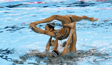 Team USA artistic swimmers perform a high-flying lift during their acrobatic routine at the 2025 World Aquatics Championships in Singapore.