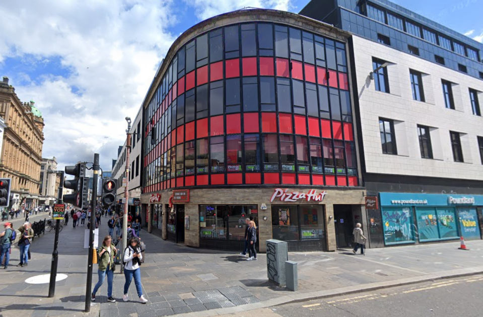 Pizza Hut restaurant on a city street.