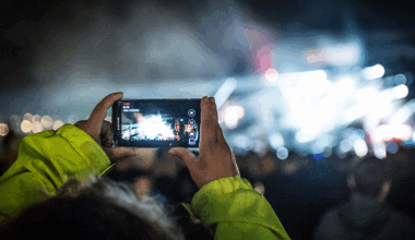 A festival goer takes a photograph on a mobile phone at Download Festival 2015.
