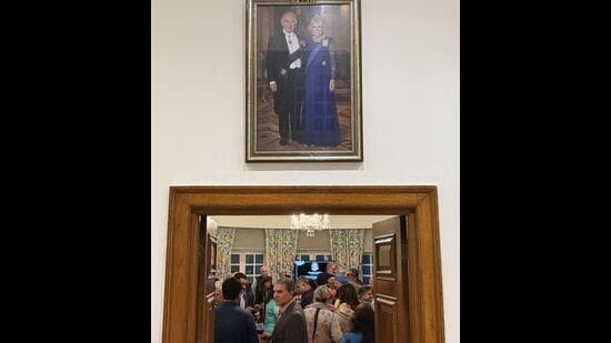 These guests sauntered into the living room, walking right under the portrait of their British hostess’s king and queen. (HT)