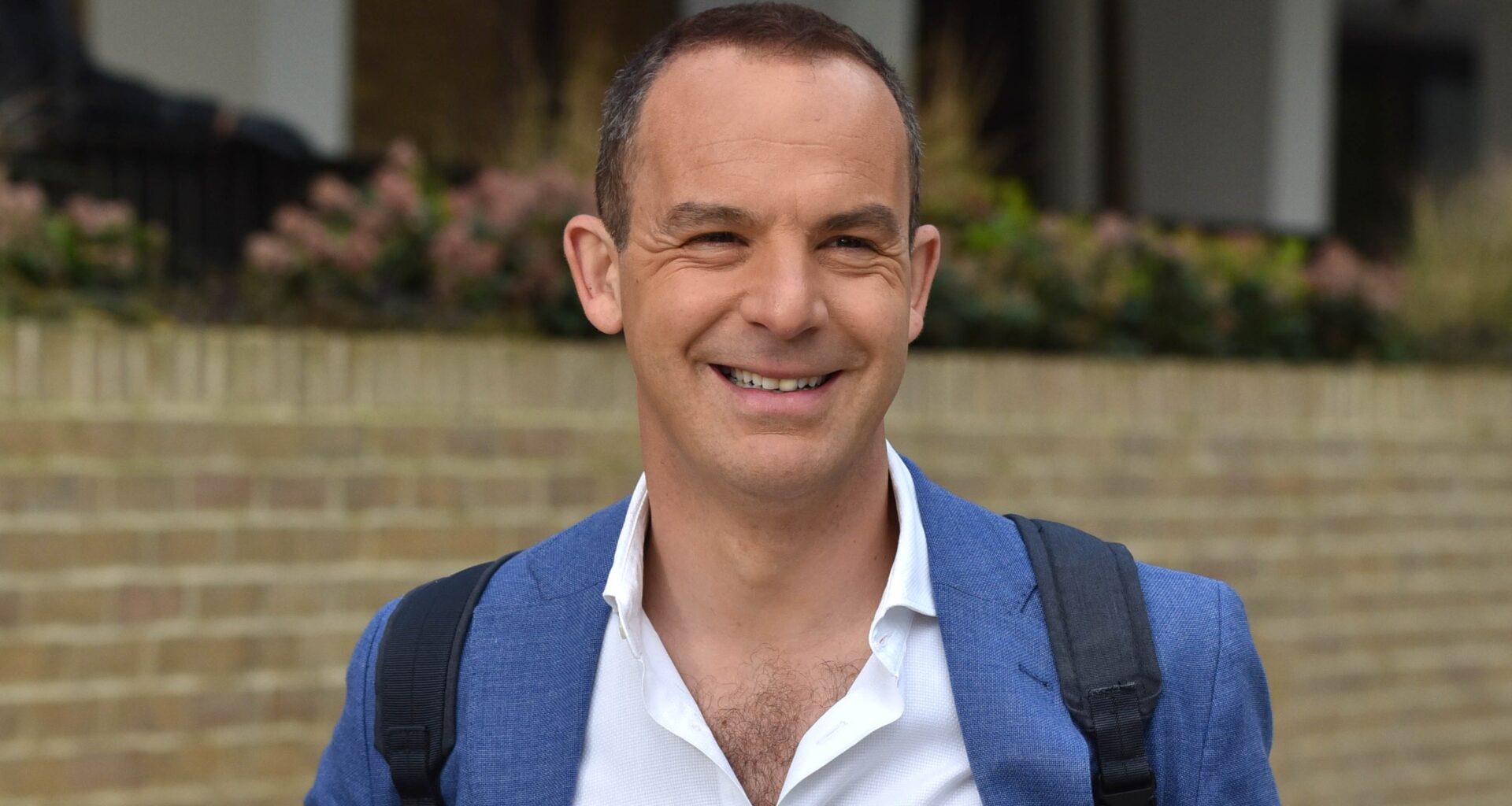 Martin Lewis smiles, wearing a shirt and blazer, as he's seen in London on April 26, 2018