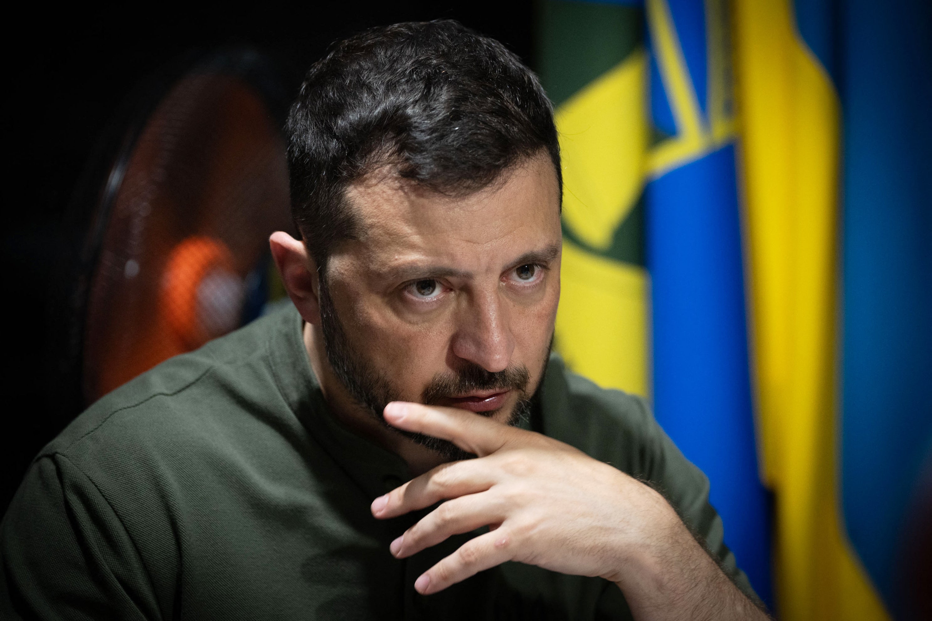 Ukraine's president Volodymyr Zelensky looks on as he meets with soldiers on the frontline positions at an undisclosed location in the Kharkiv region