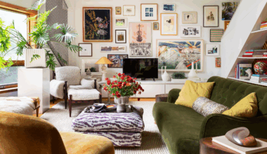 Eclectic sun drenched living room featuring a zebra patterned ottoman and cozy upholstered sofas and chairs. The far wall features a credenza styled with various sculptural objects. Above, there is a gallery wall of assorted paintings and prints.
