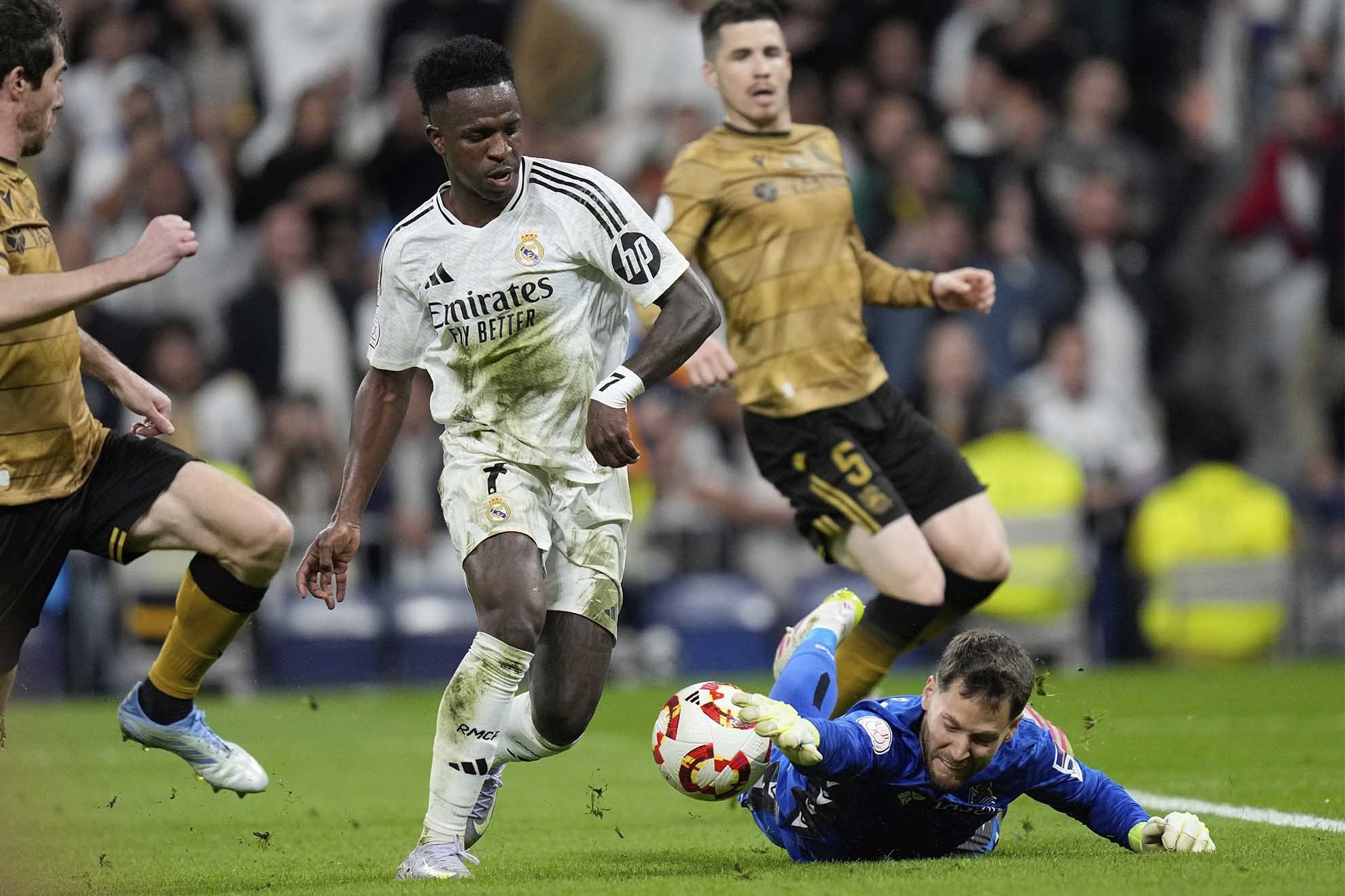 Real Sociedad's goalkeeper Alex Remiro saves in front of Real Madrid's Vinicius Junior during the Spanish Copa del Rey semifinal second leg.