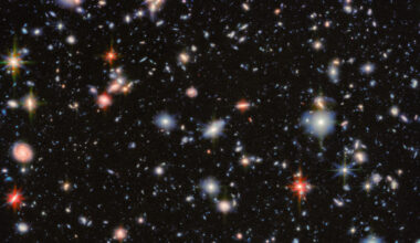 An image of deep space, showing glows of distant stars and swirls of galaxies of many different colors.