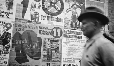 A man walks past a wall of election posters in Leipzig, by Albert Henning, 12 May 1929. © Deutsche Fotothek / Hennig, Albert. All rights reserved.