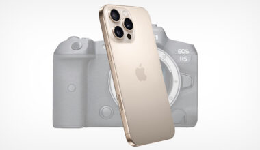 A gold iPhone with three rear cameras is positioned in front of a blurred Canon EOS R5 camera on a white background.
