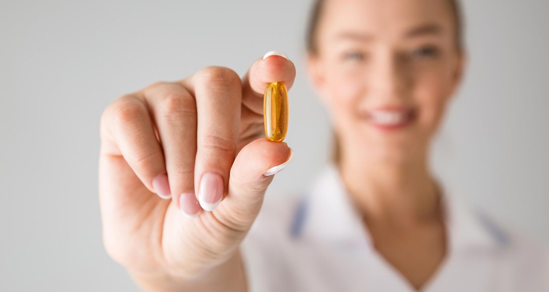 Woman Holding Vitamin Supplement Pill