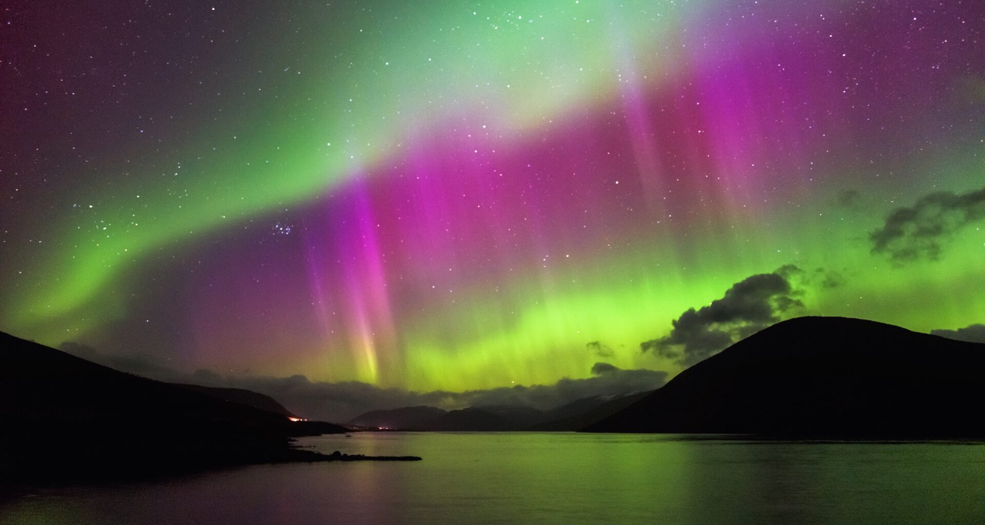 A photo of an aurora over a lake