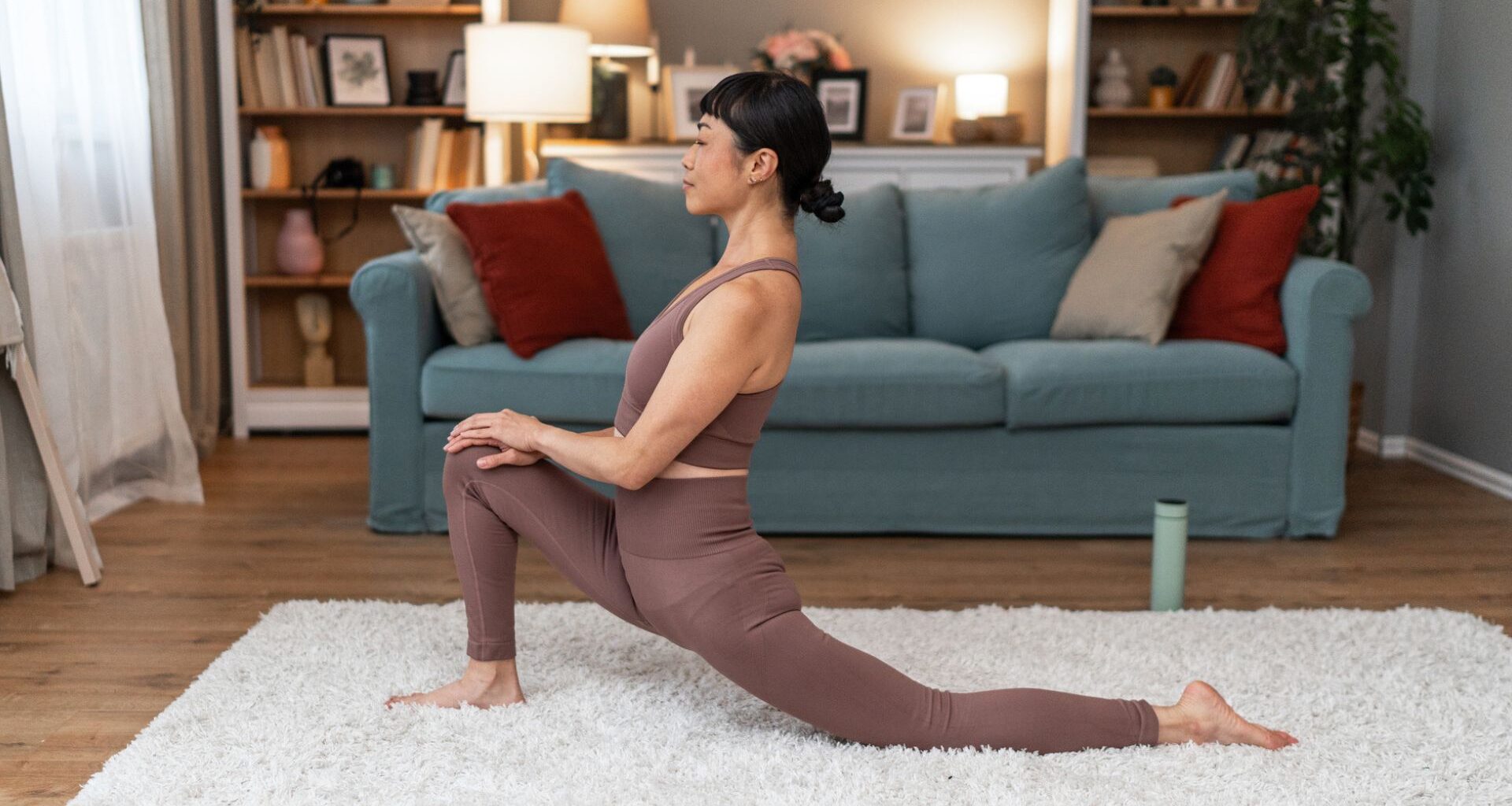 woman in lunge stretch on floor