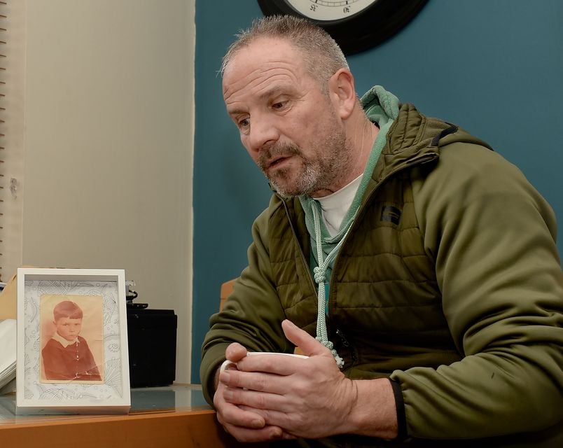 Michael O’Hare, beside a photo of himself as a child, recalls his harrowing physical and sexual abuse at the hands of Christian Brother Paul Dunleavy