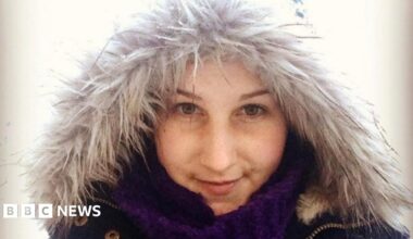 A young woman in her late 20s wearing a fluffy coat and looking into the camera.