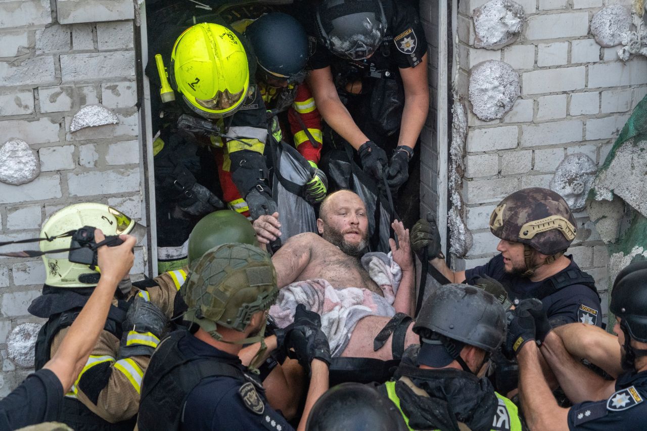 Rescuers evacuate an injured civilian after a residential building was hit following Russia's missile attack in Kharkiv, Ukraine on Monday.