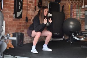 Lauren demonstrates a workout exercise