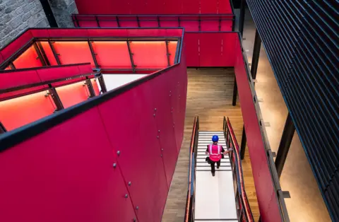 Eoin Carey A photo of the new foyer, dominated by a pink staircase