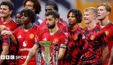 Manchester United players stand next to the Premier League Summer Series trophy