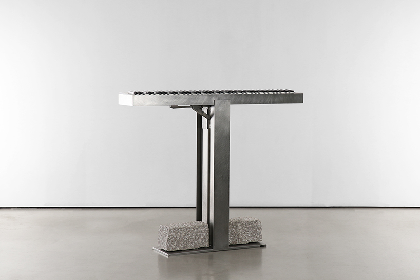 carved in steel and stone, sculptural electronic piano transforms from instrument to monolith