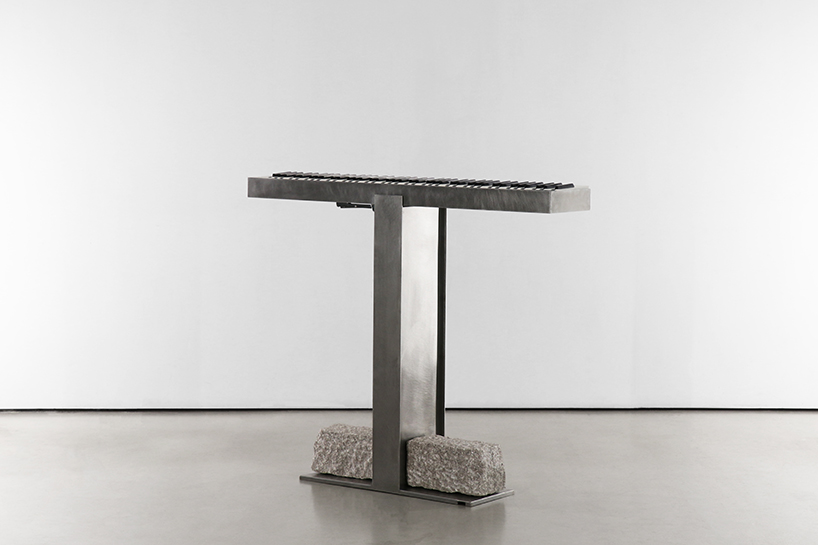 carved in steel and stone, sculptural electronic piano transforms from instrument to monolith