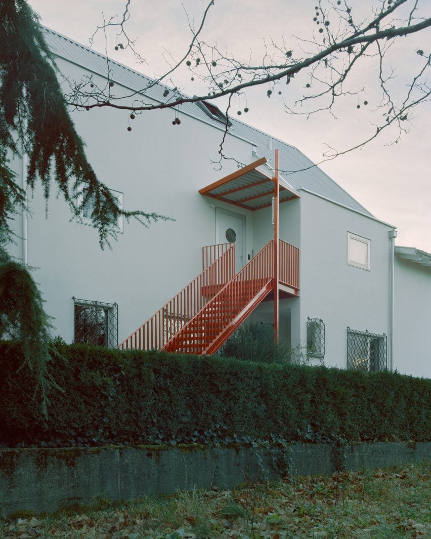 Red steel staircase leading to upper level apartment 