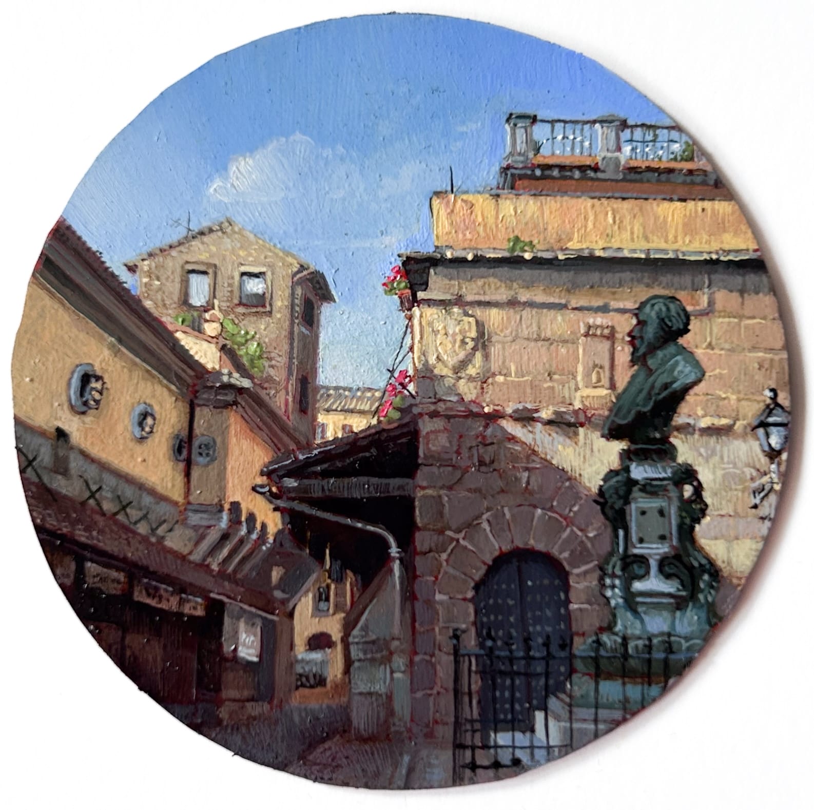 a tiny round painting of an Italian street scene