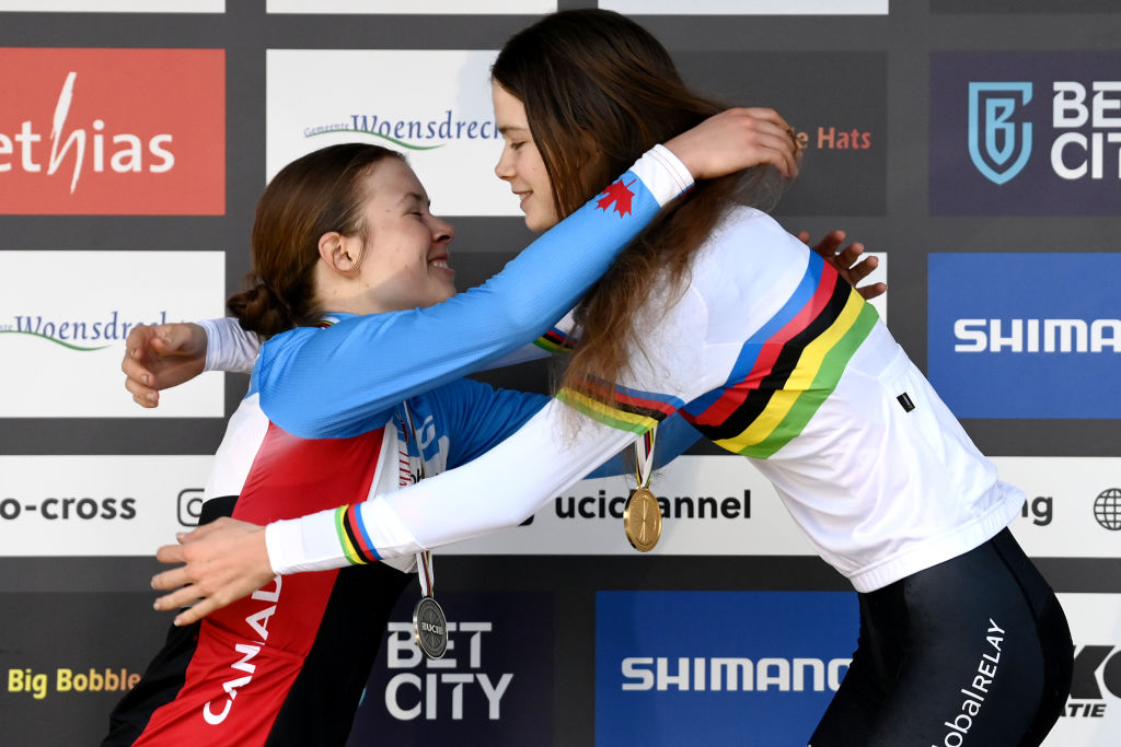 HOOGERHEIDE, NETHERLANDS - FEBRUARY 04: (L-R) Silver medalist Ava Holmgren of Canada, gold medalist Isabella Holmgren of Canada, embrace each other on the podium during the medal ceremony after during the 74th World Championships Cyclo-Cross 2023 - Women's Junior / #CXWorldCup / #Hoogerheide2023 / on February 04, 2023 in Hoogerheide, Netherlands. (Photo by David Stockman/Getty Images)