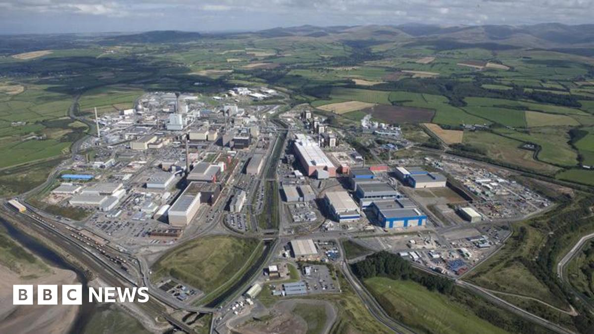 An aerial view of the Sellafield site. It is a large industrial-looking estate with several buildings and roads, surrounded by fields.