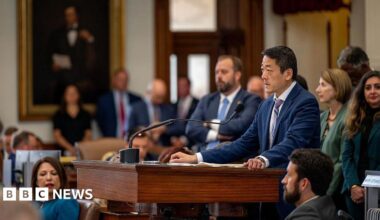 Texas state lawmakers huddle in the House chamber