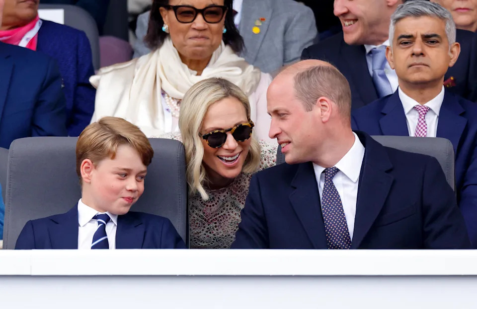 Prince William and Prince George sitting in chairs talking to Zara Tindall, who is behind them leaning forward