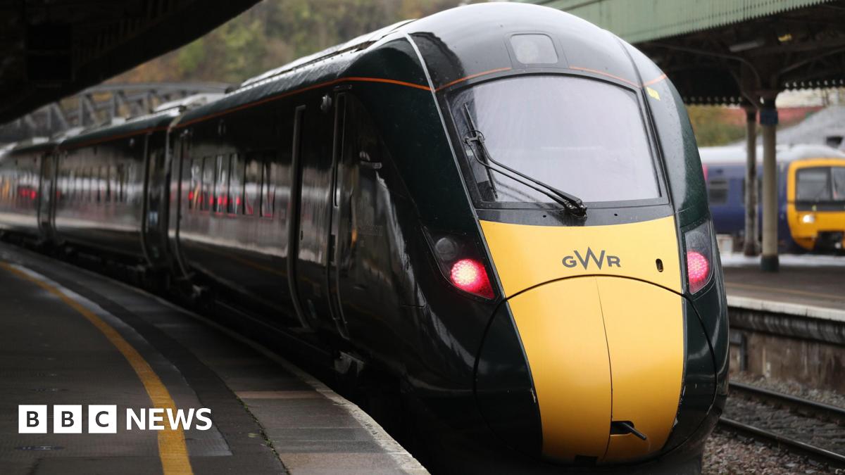 A yellow and green train with the GWR logo on the front pulls in to Bristol Temple Meads.