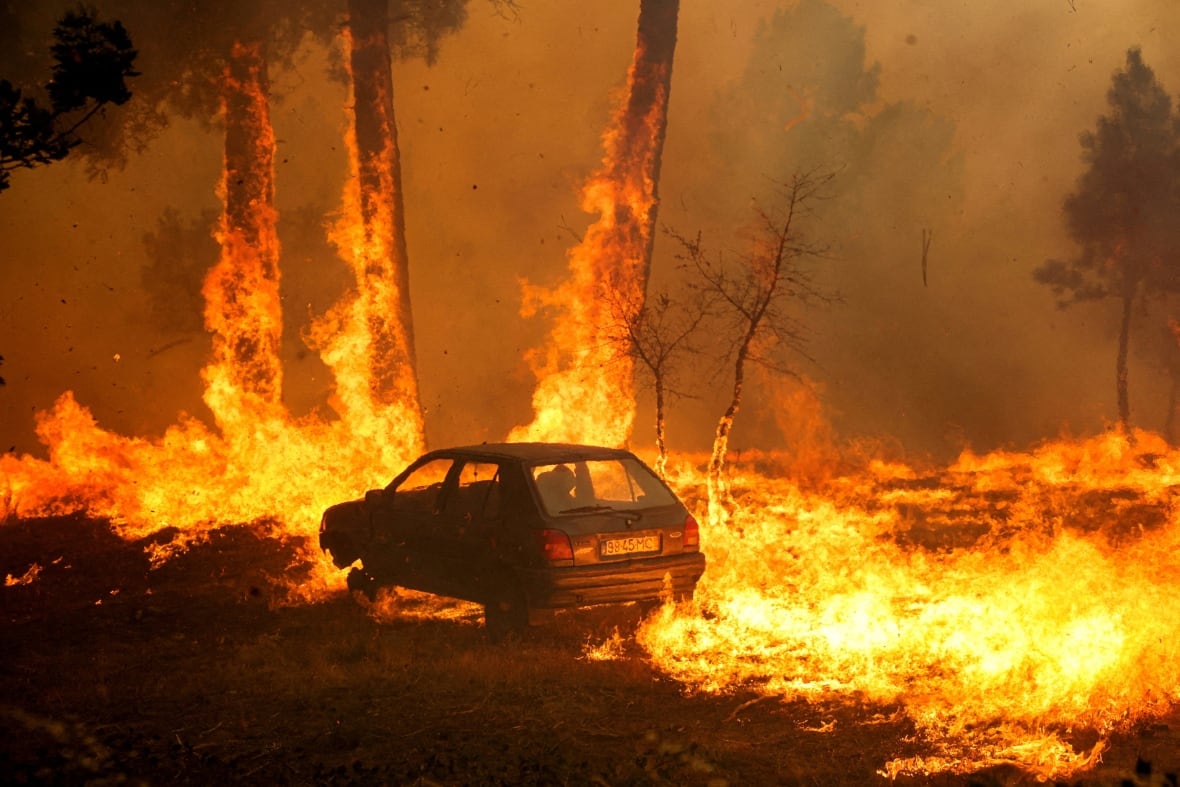 A car burns during a wildfire in Meda, Portugal, in August 2025.