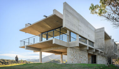 cristian nanzer’s el dragón house rises from cyclopean stone base