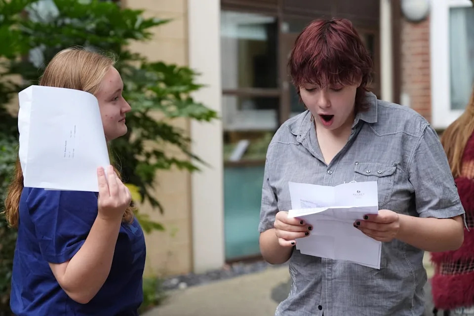 Scarlett Bowen, 16, (left) and Oliver Philpot, 16, at Putney High School in London receiving their GCSE results (Jonathan Brady/PA Wire)