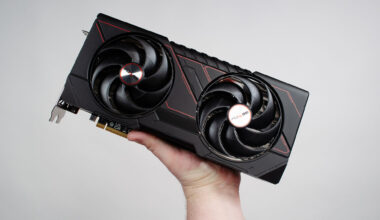 A masculine hand holding an AMD Radeon RX 9070