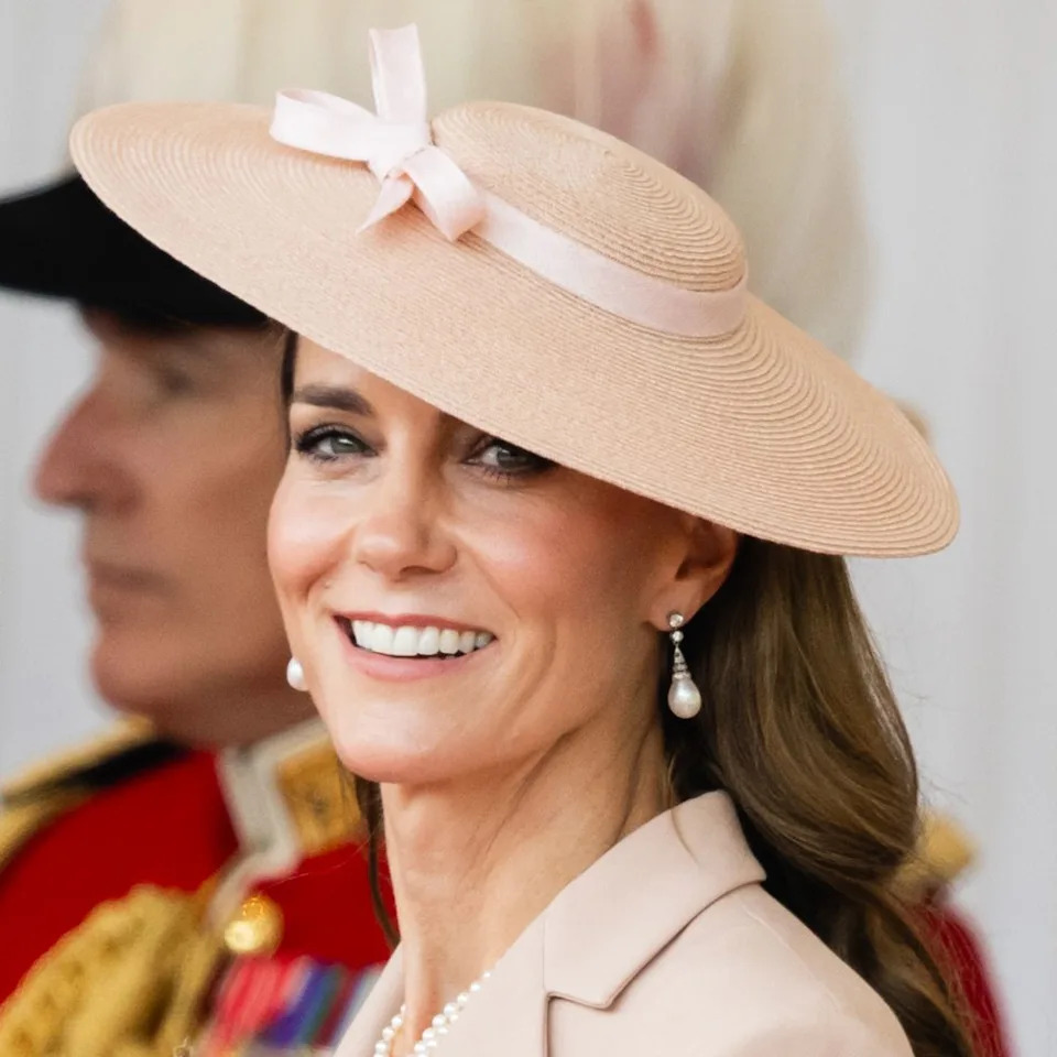  Princess Kate wearing a pink hat with a bow smiling. 