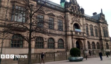 Sheffield town hall is a goth style Victorian building with large windows, a balcony and ornate stone decoration