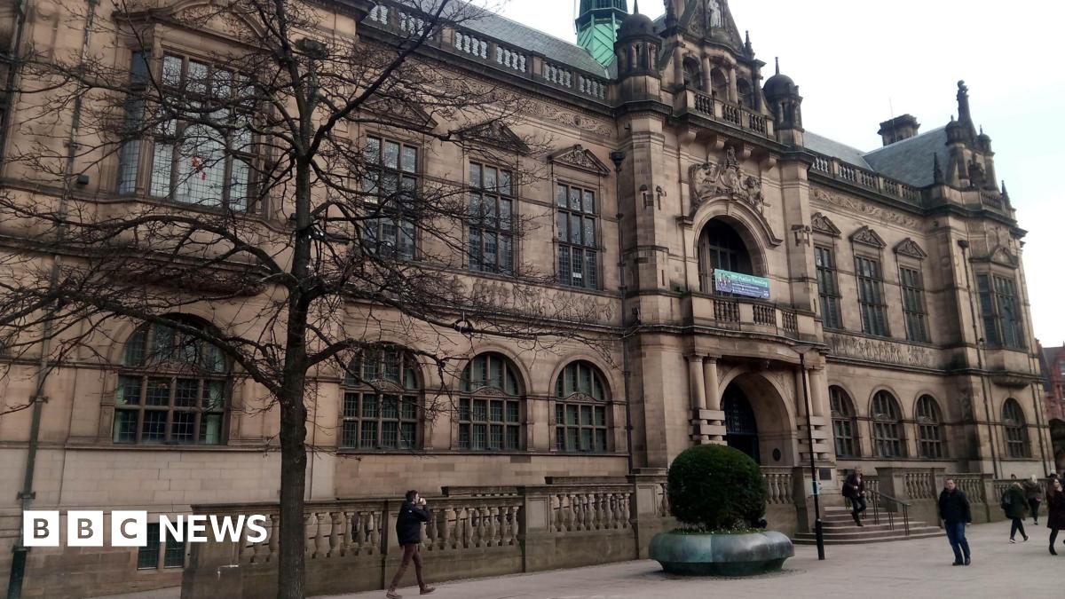 Sheffield town hall is a goth style Victorian building with large windows, a balcony and ornate stone decoration