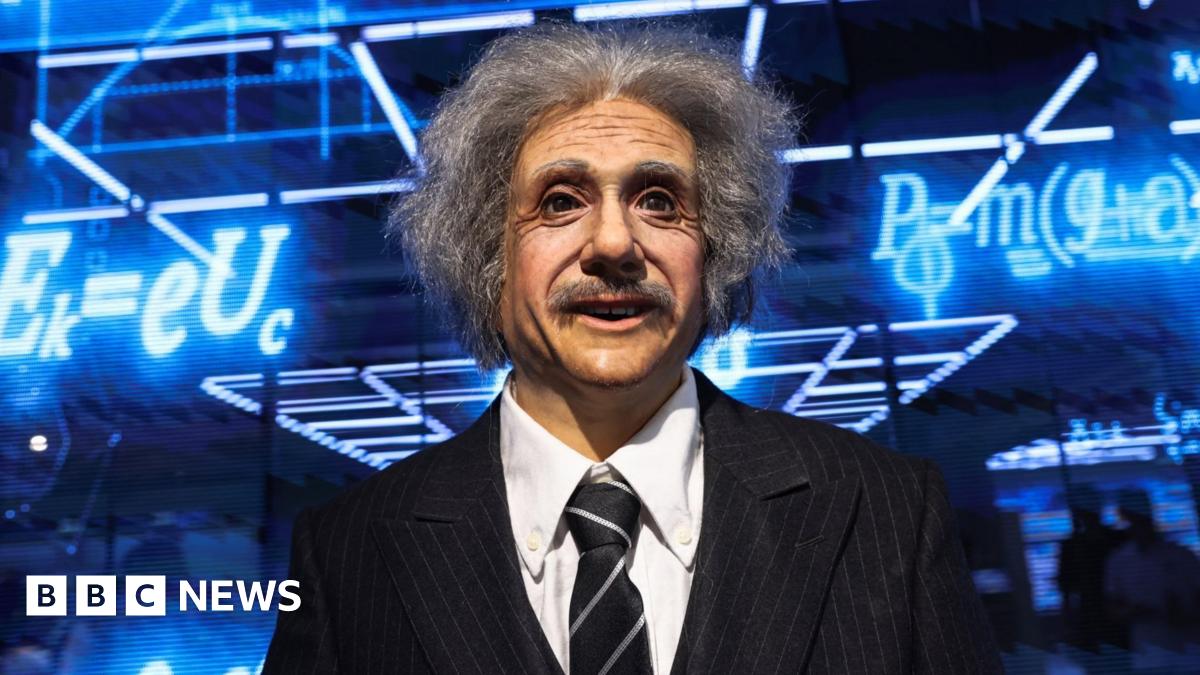 A humanoid robot in the likeness of late physicist Albert Einstein stands behind a price tag, during an organised media tour to Robot Mall, a store selling humanoid and other robots, in Beijing.