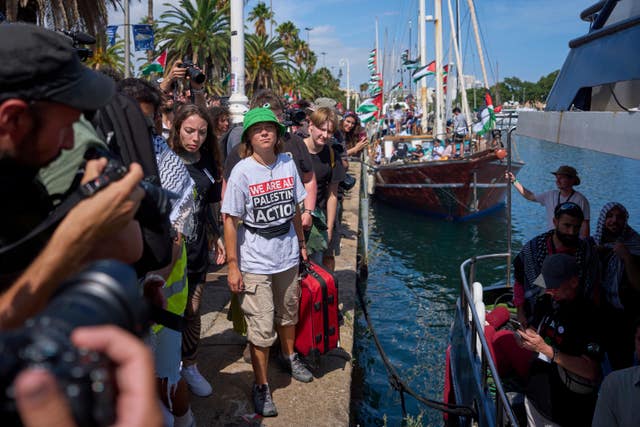 Greta Thunberg arrives to board a boat