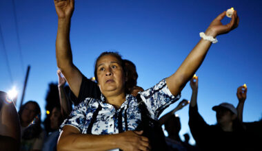 ALTADENA, CALIFORNIA - JULY 07: People attend a memorial service honoring the 19 lives lost during Eaton Fire on July 07, 2025 in Altadena, California. The memorial service was held at the edge of the property where Evelyn McClendon, 59, lived before losing her life in the fire. Today is the six-month anniversary of the Eaton and Palisades fires which claimed 30 lives and left more than 16,000 structures destroyed. (Photo by Mario Tama/Getty Images)