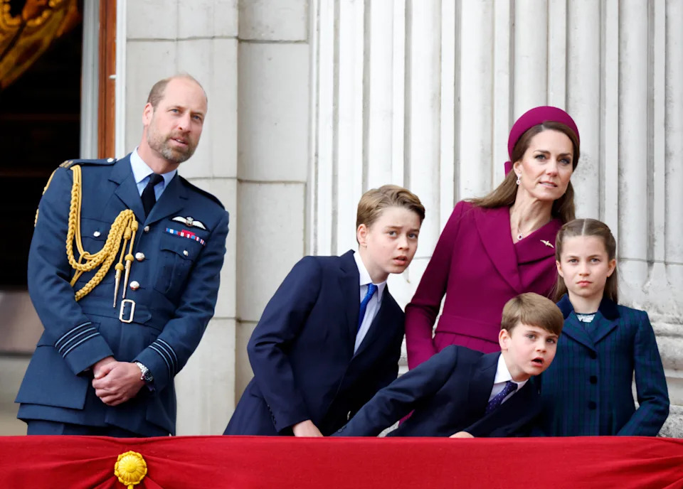 Prince William, Prince George, Princess Kate, Prince Louis and Princess Charlotte leaning to the side on the balcony at Buckingham Palace