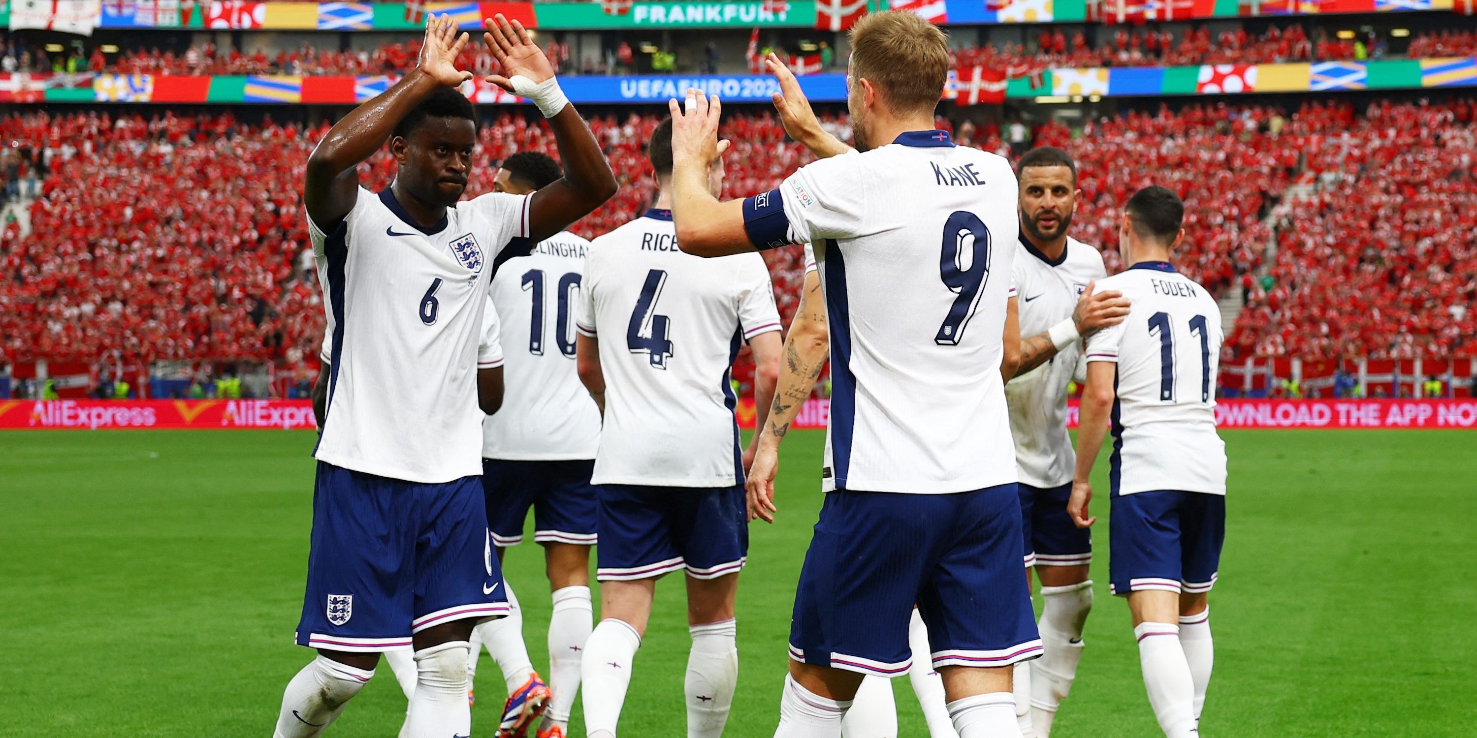 England's Harry Kane celebrates scoring their first goal with Marc Guehi