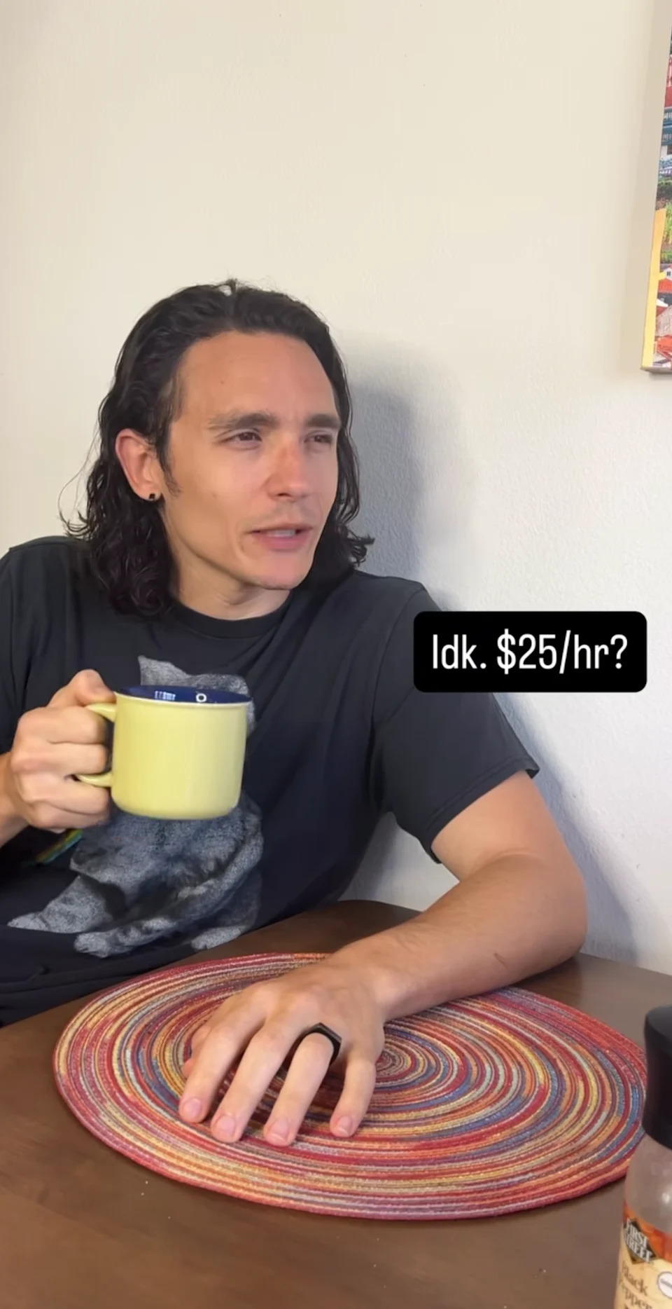 Person sitting at a table, holding a mug, with a caption bubble saying, "Idk. $25/hr?" indicating a conversation about hourly wages
